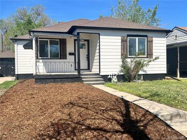 Charming single-story home with white siding, brown shutters, and a well-maintained front yard at 449 King St, Denver, CO 80204