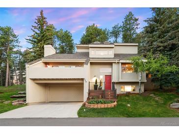 Stunning two-story home boasting a red front door, a two-car garage, and beautiful landscaping at 929 Coneflower Dr, Golden, CO 80401