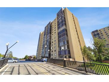 Condominium tower exterior featuring clean lines, glass windows, and well-maintained surrounding landscape at 7865 E Mississippi Ave # 1502, Denver, CO 80247