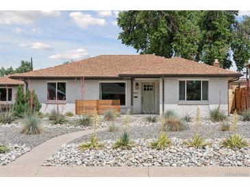 Charming single-story home boasts a well-manicured front yard with xeriscaping and lovely drought-tolerant plants at 3440 N Harrison St, Denver, CO 80205