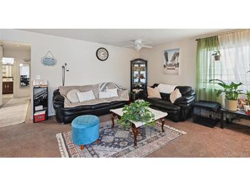 Inviting living room featuring neutral walls, plush sofas, area rug, and natural light at 5995 W Hampden Ave # 13G, Denver, CO 80227
