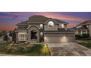 Stunning two-story home with a three-car garage and beautiful brick and siding exterior at 6911 Chestnut Ct, Parker, CO 80134