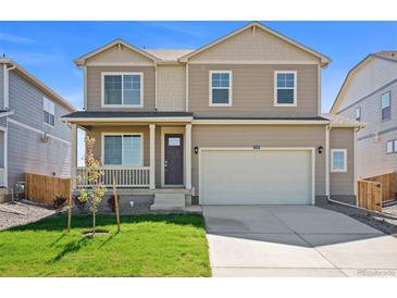 Charming two-story home with a well-manicured lawn, covered front porch, and attached two-car garage at 4853 Cattle Cross Ln, Castle Rock, CO 80104