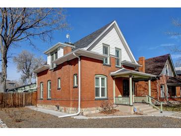 Charming brick home features a covered front porch, white trim, and a well-maintained yard at 4403 Alcott St, Denver, CO 80211