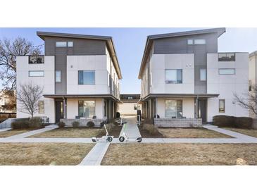 Modern townhome showcasing a contemporary design with a walkway and landscaping at 2110 Decatur St, Denver, CO 80211