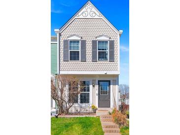 Charming two-story home featuring scalloped siding, decorative gable, and a well-manicured front lawn at 10715 Foxwood Ct, Parker, CO 80138