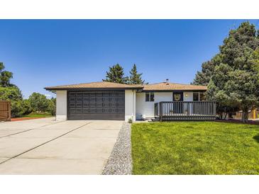 Charming exterior with a two-car garage and well-maintained lawn and inviting front porch at 4475 S Routt St, Littleton, CO 80127