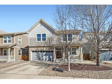 Charming two-story home with a manicured front yard, attached garage, and inviting front porch at 1824 Morningview Ln, Castle Rock, CO 80109