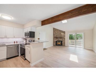 Bright, updated kitchen featuring granite countertops, stainless steel appliances, and a breakfast bar at 10251 W 44Th Ave # 3-204, Wheat Ridge, CO 80033