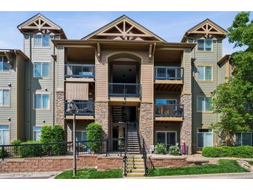 Attractive multi-story condo building with stone accents, private balconies and manicured landscaping at 8778 S Kipling Way # 304, Littleton, CO 80127