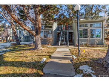 Charming townhome featuring a well-maintained lawn, mature tree, and inviting walkway at 4084 S Carson St # A, Aurora, CO 80014