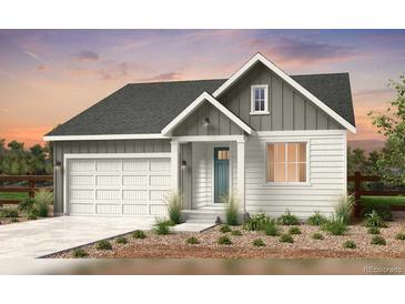 Charming single-story home featuring a two-car garage and a welcoming front porch at 4316 Ridgewalk Pt, Arvada, CO 80007