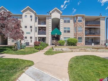 Inviting condominium complex featuring well-manicured lawns and attractive architectural details at 12348 W Dorado Pl # 204, Littleton, CO 80127
