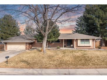 Charming single-story brick home featuring an attached garage and a well-maintained front yard at 452 Deframe Ct, Golden, CO 80401