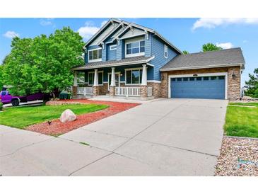 Inviting two-story home with a covered porch, blue siding, and a well-maintained front yard at 18967 W 54Th Ln, Golden, CO 80403