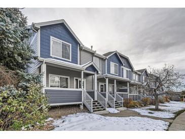 Gray and blue townhouses with snow-covered yards at 19249 E Carolina Dr # 106, Aurora, CO 80017