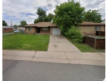 Ranch-style home with a spacious yard and attached garage at 360 S Bryant St, Denver, CO 80219