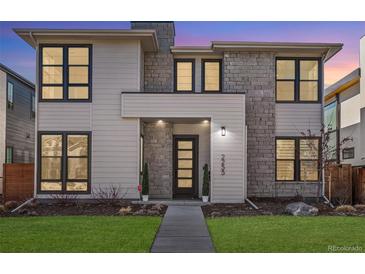 Beautiful home featuring a modern design with a stone and wood facade and professionally manicured landscaping at 2255 S Monroe St, Denver, CO 80210
