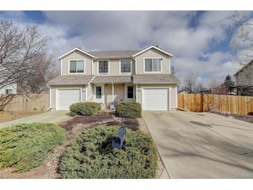 Charming townhouse with attached garage and well-maintained landscaping at 11821 W Independence Ave, Lakewood, CO 80401