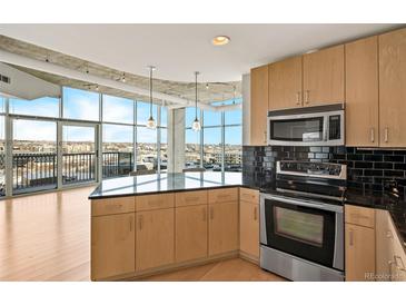 Modern kitchen with stainless steel appliances and dark countertops at 1700 Bassett St # 1105, Denver, CO 80202