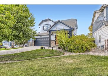 Charming two-story home featuring a two-car garage, stone accents, and a well-manicured front yard at 9544 Longford Way, Parker, CO 80134