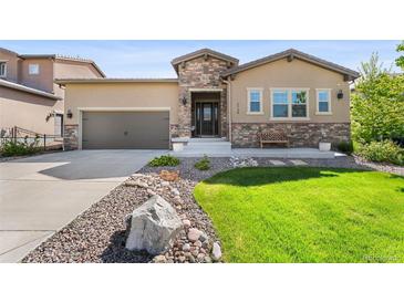 Charming single-Gathering home featuring a stone facade, well-manicured lawn, and inviting front entrance at 2134 S Poppy St, Lakewood, CO 80228