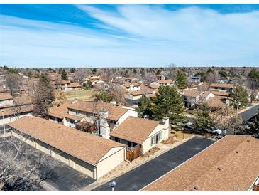 Expansive aerial view of a residential community with mature trees and well-maintained streets under a blue sky at 3657 S Laredo St # E, Aurora, CO 80013