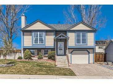 Charming two-story home featuring a well-manicured lawn, neutral siding, and an attached one car garage at 11437 W 103Rd Ave, Broomfield, CO 80021