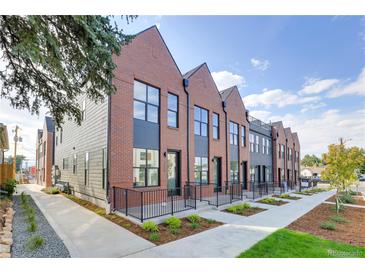 Modern brick townhouses with private patios and walkway at 4391 Zenobia St, Denver, CO 80212