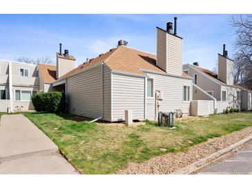 A charming townhouse featuring neutral siding, brown roofing, chimney and well-kept lawn in a suburban setting at 13635 E Yale Ave # D, Aurora, CO 80014