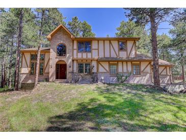 Charming two-story Tudor home with brick and stucco accents and a manicured lawn at 70 Long Bow Cir, Monument, CO 80132