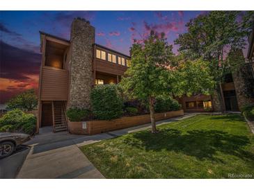 Charming multi-level condo with beautiful landscaping, a stone chimney, and outdoor access on the front at 4681 S Decatur St # 327, Englewood, CO 80110