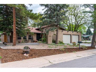 Charming single-story home boasting a brick facade, tiled roof, and a welcoming two-car garage at 8793 E Monmouth Pl, Denver, CO 80237