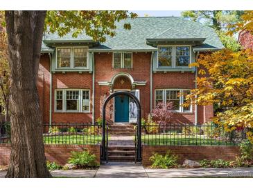Charming brick home with a well-manicured front yard and inviting entrance at 815 Gaylord St, Denver, CO 80206
