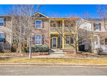 Charming two-story home with a covered porch, brick facade, and inviting entryway, set in a well-manicured neighborhood at 2667 Xanthia Ct, Denver, CO 80238