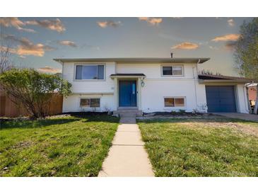 Charming two-story home with a lush front yard and a walkway leading to the front door at 846 E 114Th Pl, Northglenn, CO 80233