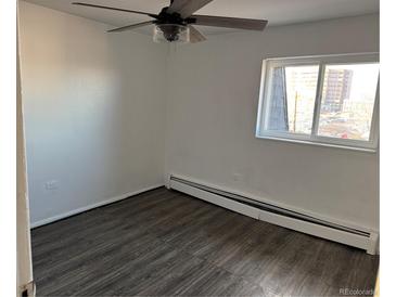 Bright bedroom features wood-look floors, a ceiling fan, and a window with great natural light at 1285 N Colorado Blvd # 4, Denver, CO 80206