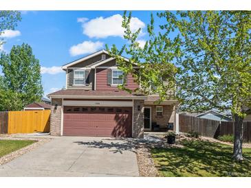 Charming two-story home featuring a two-car garage and manicured lawn in a suburban neighborhood at 13884 Lilac St, Thornton, CO 80602