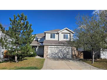 Charming two-story home with attached garage, landscaped lawn, and lovely trees at 5956 S Winnipeg St, Aurora, CO 80015