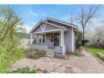Charming home featuring a classic covered front porch with a cozy and well-kept front yard landscape at 1920 S Downing St, Denver, CO 80210