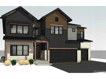 Charming two-story home with stone accents, and a two-car garage showcasing a modern architectural style at 933 Saint Andrews Ln, Louisville, CO 80027