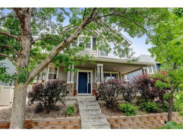 Charming two-story home with a welcoming porch and well-maintained landscaping at 13025 Umatilla Ct, Denver, CO 80234