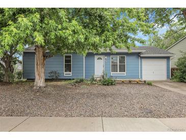 Charming blue single-story home with a well-maintained front yard and mature shade tree at 3224 S Dudley St, Lakewood, CO 80227