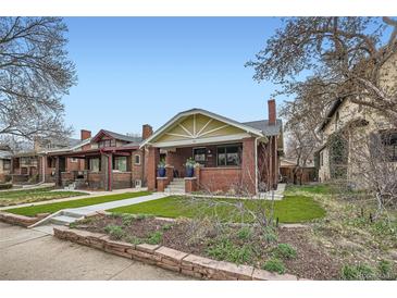 Charming brick home with a well-manicured lawn and inviting front porch at 586 S Corona St, Denver, CO 80209