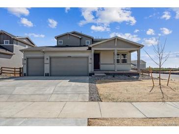 Attractive two-story home featuring a three car garage and covered front porch at 14366 Heritage Dr, Mead, CO 80504