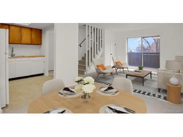 Bright living room with dining area, balcony access, and modern furnishings creating a cozy atmosphere at 1149 Columbine St # 202, Denver, CO 80206