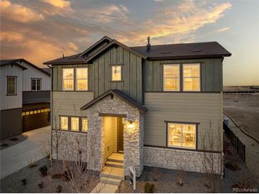 Charming two-story home with a stone-accented entrance, complemented by a well-manicured front yard at 23751 E 40Th Ave, Aurora, CO 80019