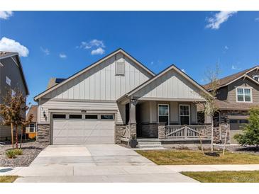 Charming single-Gathering home showcasing a well-manicured lawn and inviting covered front porch at 24197 E Ada Ave, Aurora, CO 80018