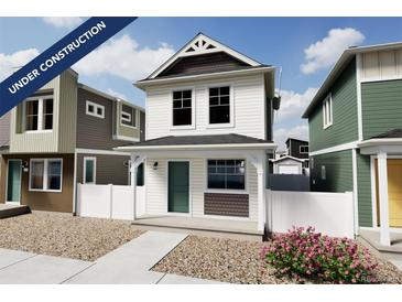 Charming two-story home featuring a covered porch, white siding, and tasteful architectural details at 10346 Uvalda Ave, Commerce City, CO 80022