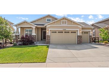 Charming home featuring a three-car garage and meticulously maintained front yard at 17956 Gypsum Canyon Ct, Monument, CO 80132